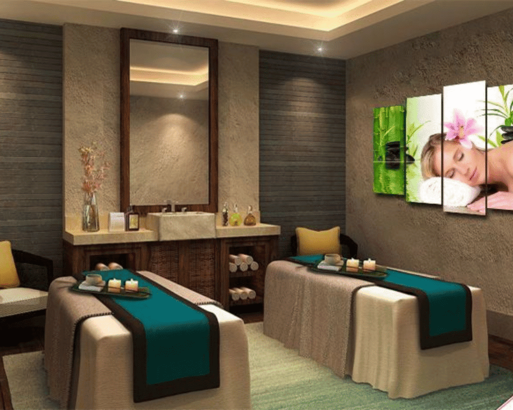 Luxurious spa treatment room with massage tables, relaxing candles, and aromatherapy diffuser, designed for wellness and relaxation in a serene, upscale setting.